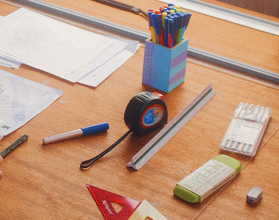 Desk with planning documents and stationary on it